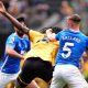 Referee Paul Tierney speaks with Lisandro Martinez of Manchester United after showing him a red card for pulling the hair of Dominic Calvert-Lewin of Leeds United