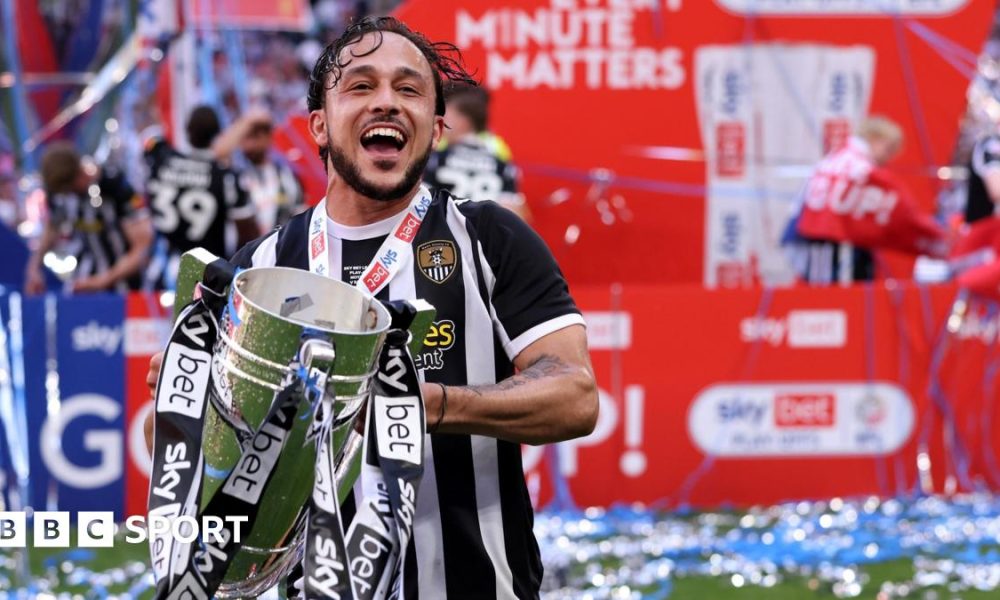 Jodi Jones holds the League Two play-off final trophy at Wembley