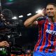 Crystal Palace's Maxence Lacroix cups his right ear with his right hand as he stands next to a TV camera
