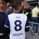 A Tottenham fan wearing shirt saying 'We 8 Arsenal'