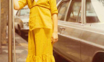 The author, age 12, in front of her family's NYC apartment building.