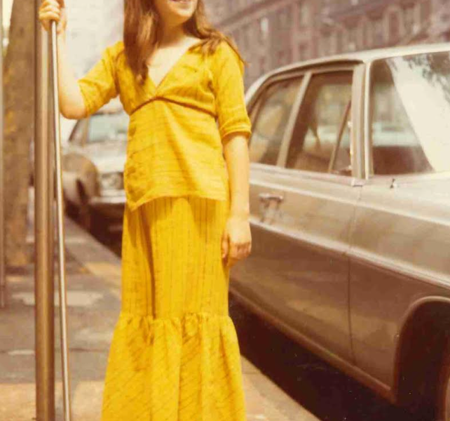 The author, age 12, in front of her family's NYC apartment building.