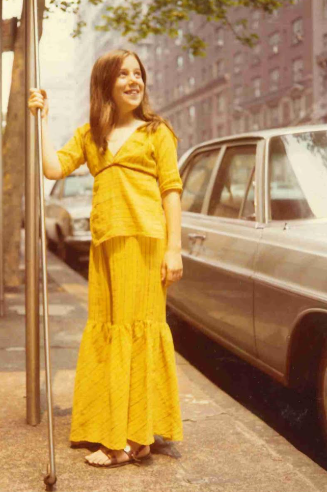 The author, age 12, in front of her family's NYC apartment building.