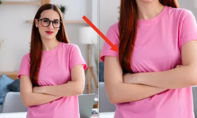 Professional young woman with glasses standing arms crossed in a bright home office, exuding confidence and competence
