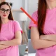 Professional young woman with glasses standing arms crossed in a bright home office, exuding confidence and competence