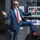 Reform UK leader Nigel Farage poses to show off his socks as he visits a polling station in Walton-on-the-Naze.