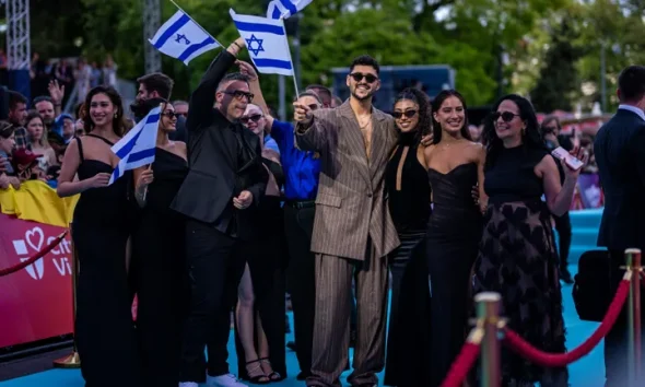 Noam Bettan posing with members of the Israeli delegation during this year's Eurovision opening ceremony