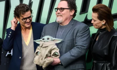 Pedro Pascal, Sigourney Weaver and Jon Favreau (with Grogu) at a The Mandalorian And Grogu fan event in London earlier this month