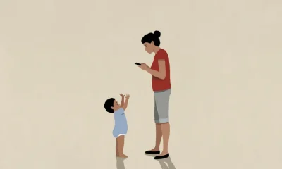 Baby boy reaching for distracted mother using smart phone