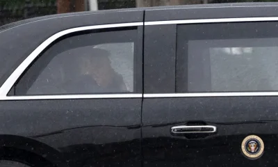 President Donald Trump sits at the back of the presidential limousine as it drives outside the Walter Reed National Military Medical Center from the White House on May 15, in Bethesda, Maryland.