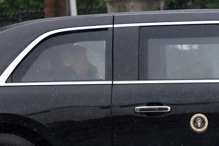 President Donald Trump sits at the back of the presidential limousine as it drives outside the Walter Reed National Military Medical Center from the White House on May 15, in Bethesda, Maryland.