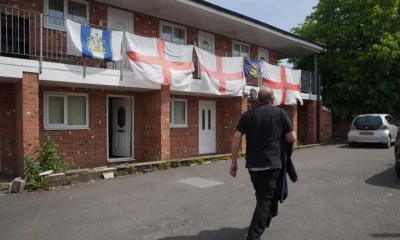 View at flats decorated with the St George's Cross flag in Ashton-in-Makerfield where Andy Burnham will stand as Labour's candidate for the by-election in Makerfield, England, Friday, May 22, 2026.