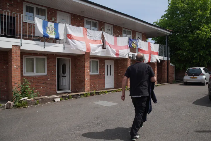 View at flats decorated with the St George's Cross flag in Ashton-in-Makerfield where Andy Burnham will stand as Labour's candidate for the by-election in Makerfield, England, Friday, May 22, 2026.