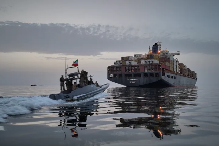 In this photo released by Tasnim News Agency, a Revolutionary Guard Navy (IRGC) speedboat approaches the cargo ship Epaminondas during what state media described as the seizure of one of two vessels accused of violations in the Strait of Hormuz on April 21.