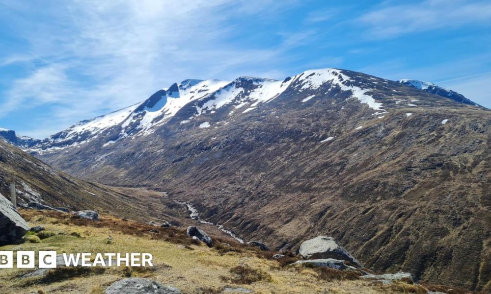 Photograph of a mountain with snow on the peaks along with sunny spells