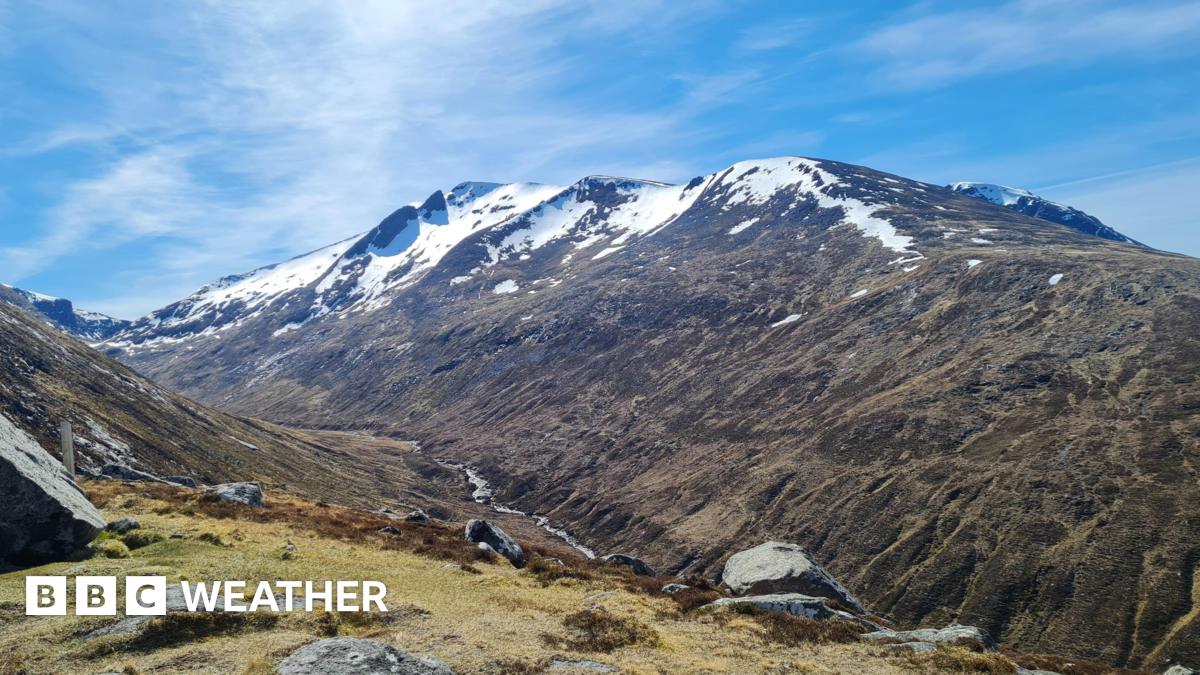 Photograph of a mountain with snow on the peaks along with sunny spells
