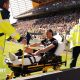 Xavi Simons being wheeled down a touchline on a stretcher