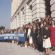 Archive photo of a line of people holding a banner that says 'Transgender and proud! And we vote'.