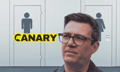 burnham Public toilet doors in the background. Andy Burnham, head and shoulders in the foreground looking perplexed. The Canary logo is on the left hand side.