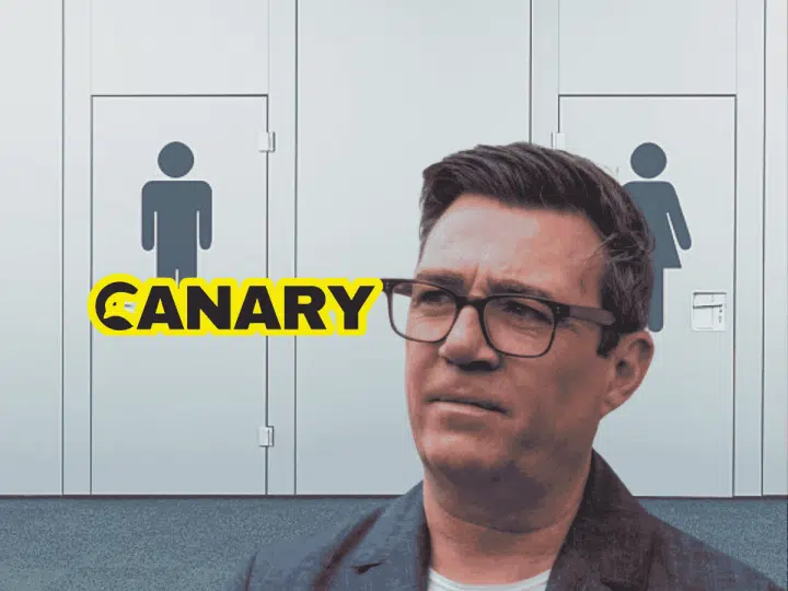 burnham Public toilet doors in the background. Andy Burnham, head and shoulders in the foreground looking perplexed. The Canary logo is on the left hand side.