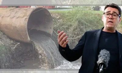 Andy Burnham in front of a sewage pipe