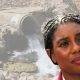 Kemi Badenoch of the Tories in front of a sewage pipe