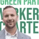 Zack Polanski smiling in front of the new Worker's Charter leaflet