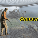 A picture of a small cage with pheasants in it in the background. One of them is dead. In the foreground we have a hunter with a gun looking back at the camera. One the right hand side is the Canary logo
