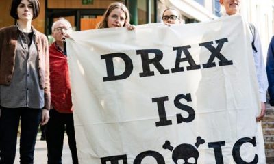 Axe Drax activists hold a banner saying Drax Is Toxic