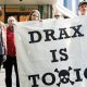 Axe Drax activists hold a banner saying Drax Is Toxic