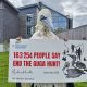 Rob Pownall, in gannet costume, holds a giant cheque representing a petition to NatureScot