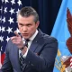 Pete Hegseth points at someone or something with his index finger