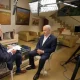 Israeli Prime Minister Benjamin Netanyahu sits across from CBS News reporter Major Garrett in a living room setting with the standing lights shining on them