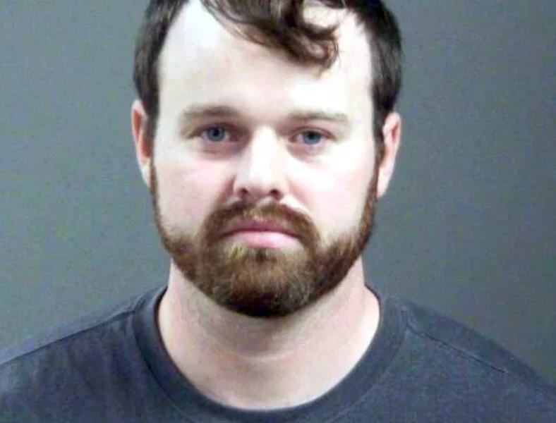 Joseph Duggar booking photo, a married father-of-four and the younger brother of convicted sex offender Josh Duggar was arrested on Wednesday in connection with allegations that he touched a nine-year-old girl on her underwear and genitals.