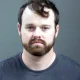 Joseph Duggar booking photo, a married father-of-four and the younger brother of convicted sex offender Josh Duggar was arrested on Wednesday in connection with allegations that he touched a nine-year-old girl on her underwear and genitals.
