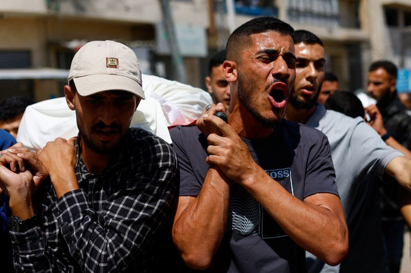 Palestinians mourn slain Hamas militant chief as Israel escalates Gaza attacks