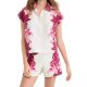 A woman wearing a white-and-pink floral top and matching shorts