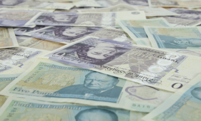 British bank notes laid flat. Sunday Times Rich List features 350 wealthy families or individuals resident in the UK