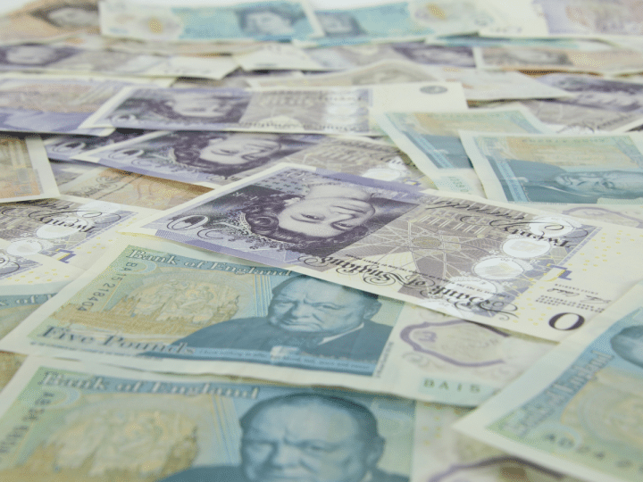 British bank notes laid flat. Sunday Times Rich List features 350 wealthy families or individuals resident in the UK