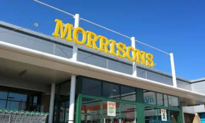 Morrisons supermarket sign against a blue sky Male sanitary bins