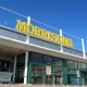 Morrisons supermarket sign against a blue sky Male sanitary bins