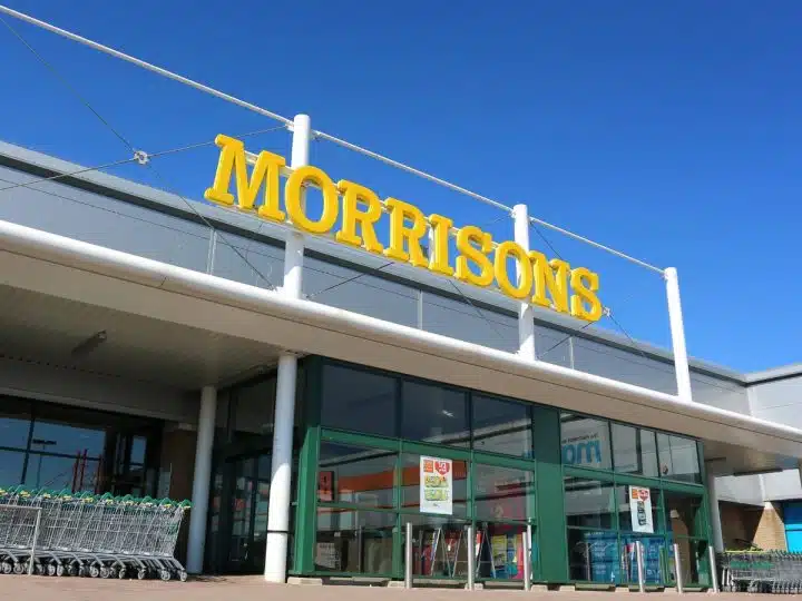 Morrisons supermarket sign against a blue sky Male sanitary bins