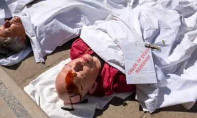 Christian Climate Action protesters stage a die-in at the Treasury over Rosebank