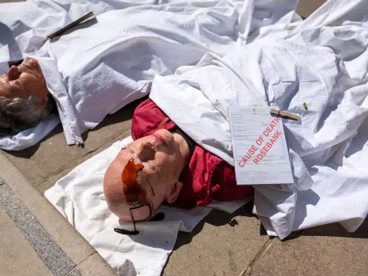 Christian Climate Action protesters stage a die-in at the Treasury over Rosebank