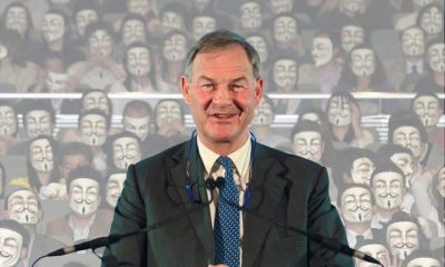 Rupert Lowe in front of masked face Restore