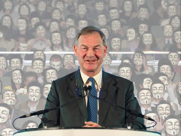 Rupert Lowe in front of masked face Restore