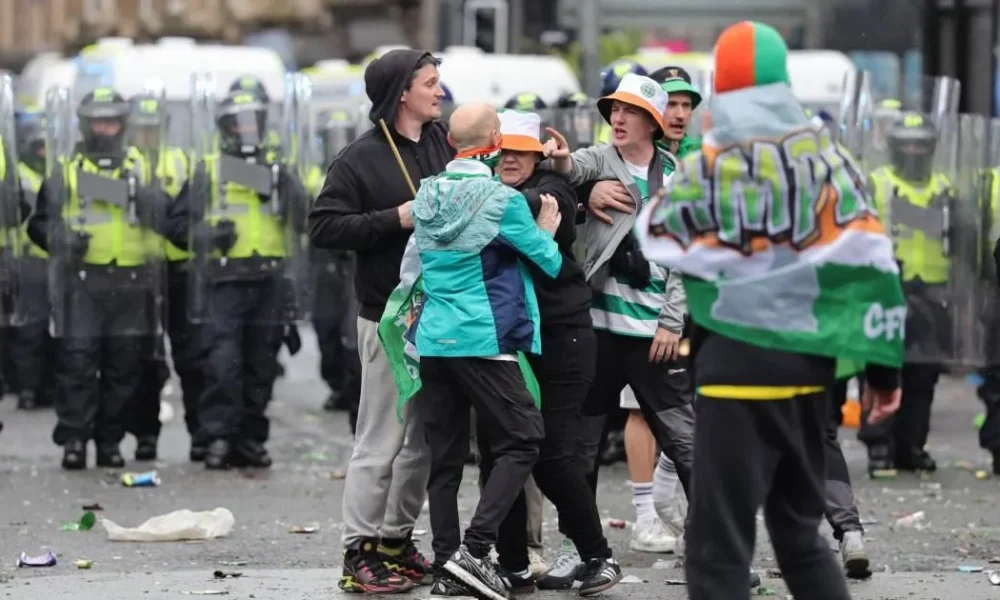 Celtic fans pelt riot police with bottles as fights break out in Glasgow | Football
