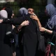 Female Muslim mosque members embrace in the parking lot of the Islamic Center of San Diego (ICSD) on May 19, 2026 in San Diego, California.