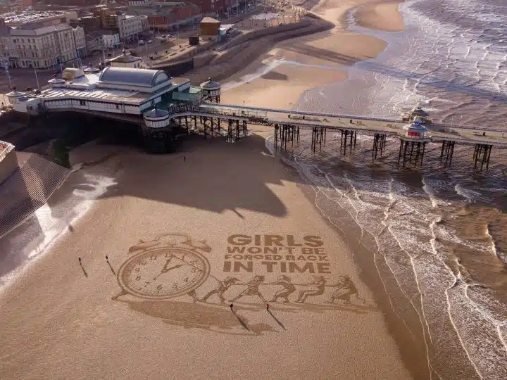 Sand art by Plan International UK Girls Won't Be Forced Back In Time