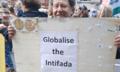 Tony Greenstein holding the 'Globalise the Intifada' slogan poster at the Nakba Day march in London on 16 May 2026